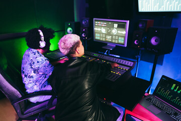 Music producers mixing new record album inside production studio room - Focus on woman head