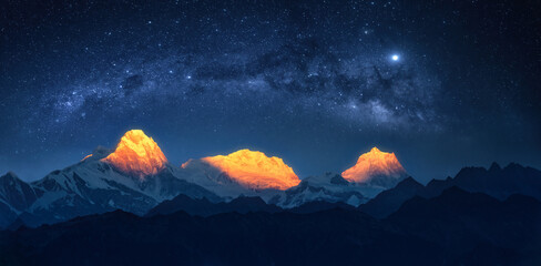 Panoramic view of snowy mountains and starry sky above famous Annapurna nature reserve, trekking route, Nepal