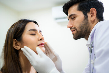 Doctor wear glove and check face skin condition before plastic surgery. Beautician touching woman face by hand. Cosmetic treatment on facial skin. Service, lifestyle and enhancement. Reduce wrinkles