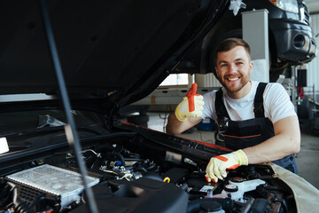 technician working on checking and service car in  workshop garage