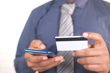 Man hand holding credit card and using smart phone shopping online 