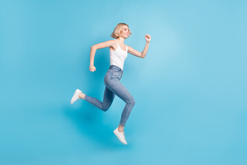 Fototapeta na wymiar Full length profile photo of carefree charming lady look empty space rush isolated on blue color background