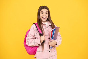 surprised child girl wear pink checkered shirt carry school bag and notebooks, study