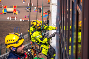Climbers wash the glazing of the facade