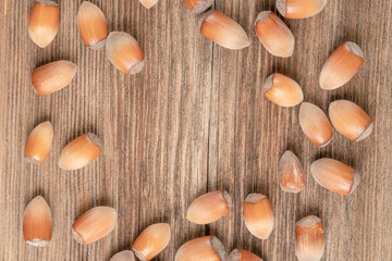 hazelnuts with nutshells on a wooden table