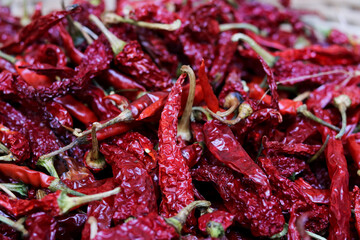 Closeup Pile of air-dried red chili peppers background. Hot and spicy dry red chillies.