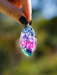 pendant with a colorful agate on blurred colorful background © skif55