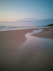 Sand,seashore,sky and sea.