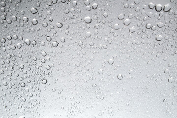 Water droplets and raindrops on clear glass