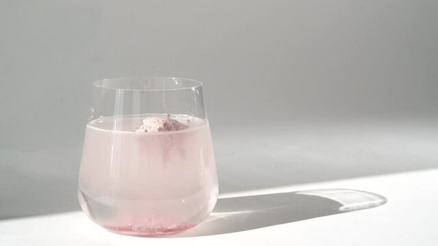 Collagen powder dissolves in glass of water for skin care. Super food additives.