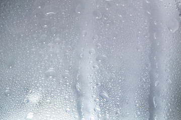 Water droplets and raindrops on clear glass