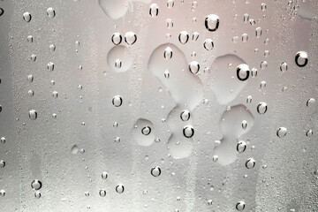 Water droplets and raindrops on clear glass