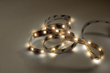 Led strip tape lightiong isolated in dark background. Diode as a component for home made lighting. Diy and save energy concept.