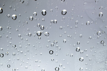 Water droplets and raindrops on clear glass