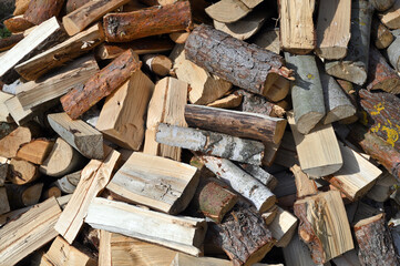 Firewood background - chopped firewood on a stack