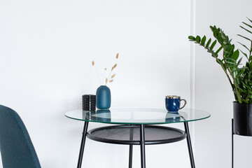 Trendy workplace with glass table in home scandi interior. Stylish minimalistick workplace, copy space