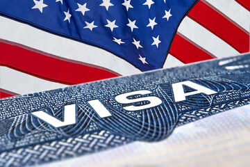 Obraz premium US American visa on passport over an American flag background. 