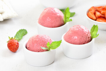 Strawberry ice cream scoop in bowl