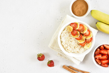 Oatmeal porridge with strawberry, banana in bowl