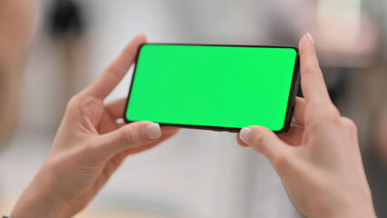 Female Watching Smartphone with Green Chroma Key Screen