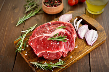 Raw beef steak on cutting board