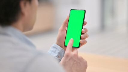 Rear View, Man using Smartphone with Green Chroma Key Screen