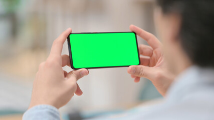 Man Watching Smartphone with Green Chroma Key Screen