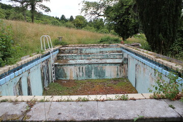 empty and weathered pool in summer