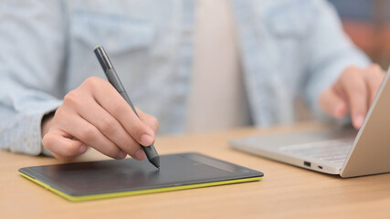 Male Hands Designing with Stylus on Tablet, Close up