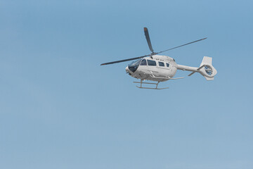 Helicopter for emergency evacuation of patients flying with blue sky background
