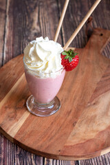 strawberry smoothie on a wooden table 