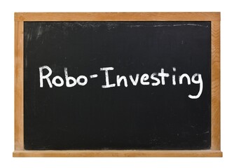 Obraz premium Robo investing written in white chalk on a black chalkboard isolated on white