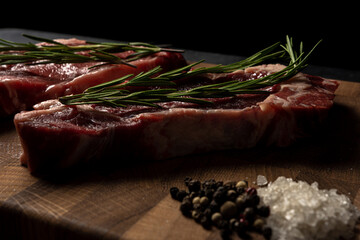 Raw marbled beef steak on a wooden cutting board. Top class marbled beef. Graphite-colored table top.