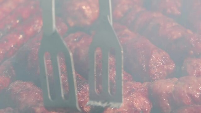 Assorted delicious pork meat and sausages grilled on a charcoal barbeque.