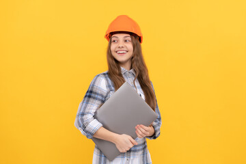 teen girl in helmet use laptop. builder kid hold computer. building and construction. webinar.