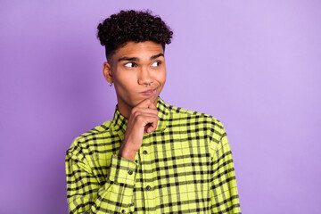 Portrait of attractive suspicious guy wear checked shirt thinking copy space isolated over bright violet purple color background