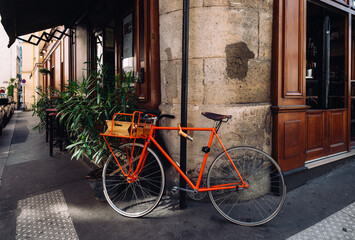 Fototapeta na wymiar Cozy street with old bicycle in Paris, France. Architecture and landmarks of Paris. Postcard of Paris