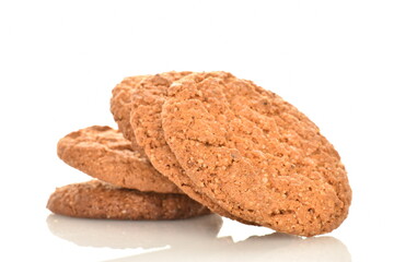 Several fragrant dark brown oatmeal cookies, close-up, isolated on white.
