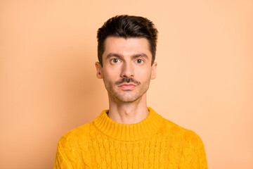 Photo portrait of serious man with mustache wearing bright yellow sweater isolated on pastel beige color background