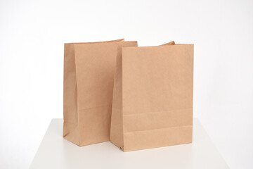 Two eco-friendly paper bags for gifts or packaging on a white background