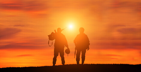 Fototapeta na wymiar Military man and military woman on sunset background is symbol of equal rights.