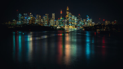 City skyline at night with water reflections