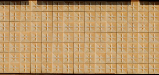 Old weathered vintage sixties tiled wall with faded colors and raised geometric patterns,...