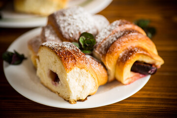 baked sweet homemade buns with plum inside