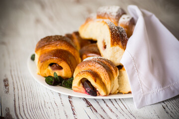 baked sweet homemade buns with plum inside