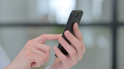 Close up of Young Man using Smartphone