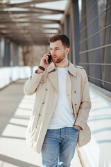 Man walks down the street and talks on phone