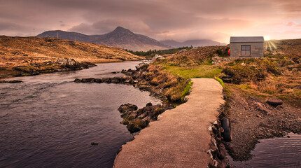 Beautiful morning sunrise at Owenmore river with mountains in the background in Connemara, county Galway, Ireland 