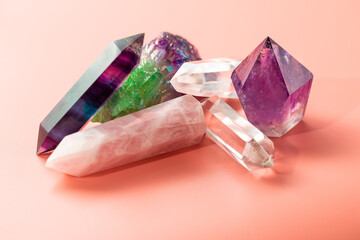 Various crystals for healing and magical practices. Faceted amethyst, rose quartz, fluorite, rock crystal, quartz cluster on pastel background - 429625962
