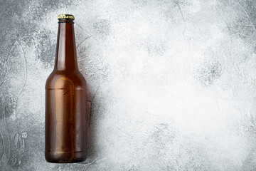 Beer bottle, on gray stone background, top view flat lay, with copy space for text